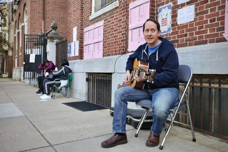 Musician performing in front of a Polling place