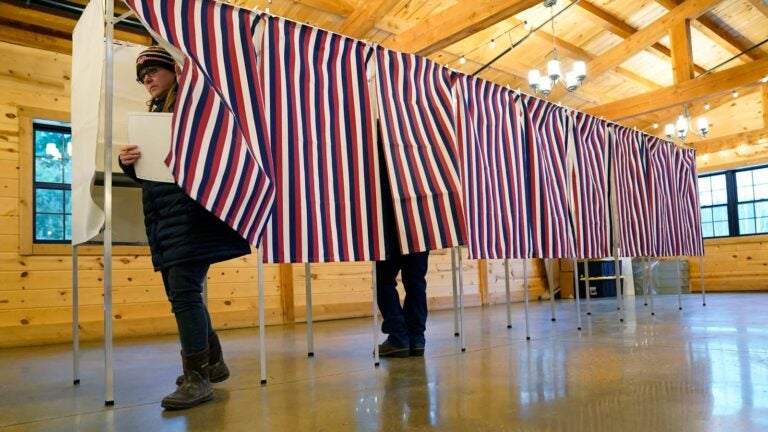 People in a voting booth