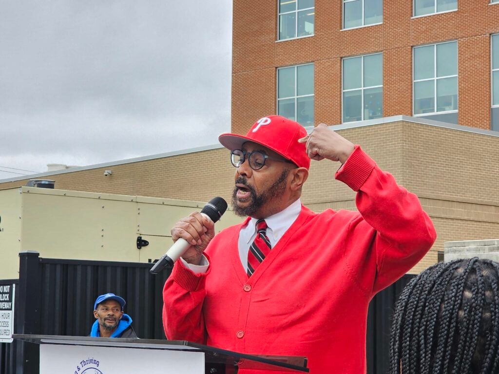 Curtis Jones speaking into a microphone at a rally