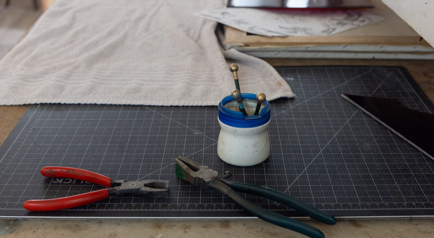 two sets of pliers and other tools on a desk