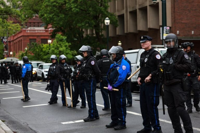 Police in riot gear block access to Penn's campus green where crews were clearing the protest encampment.