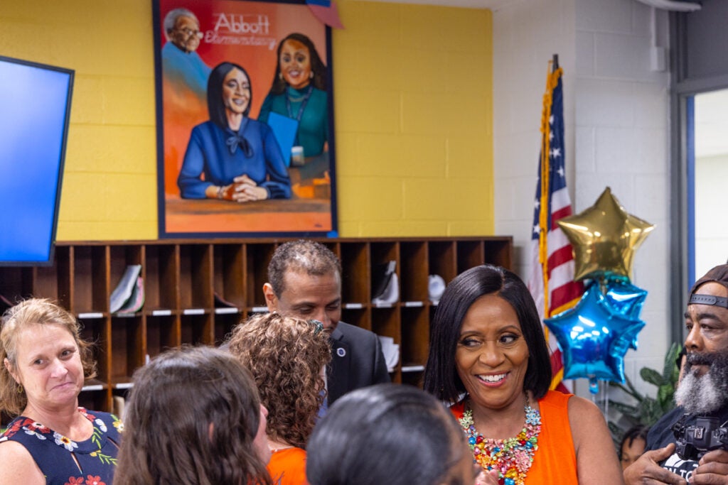 Joyce Abbott smiles in a room of people