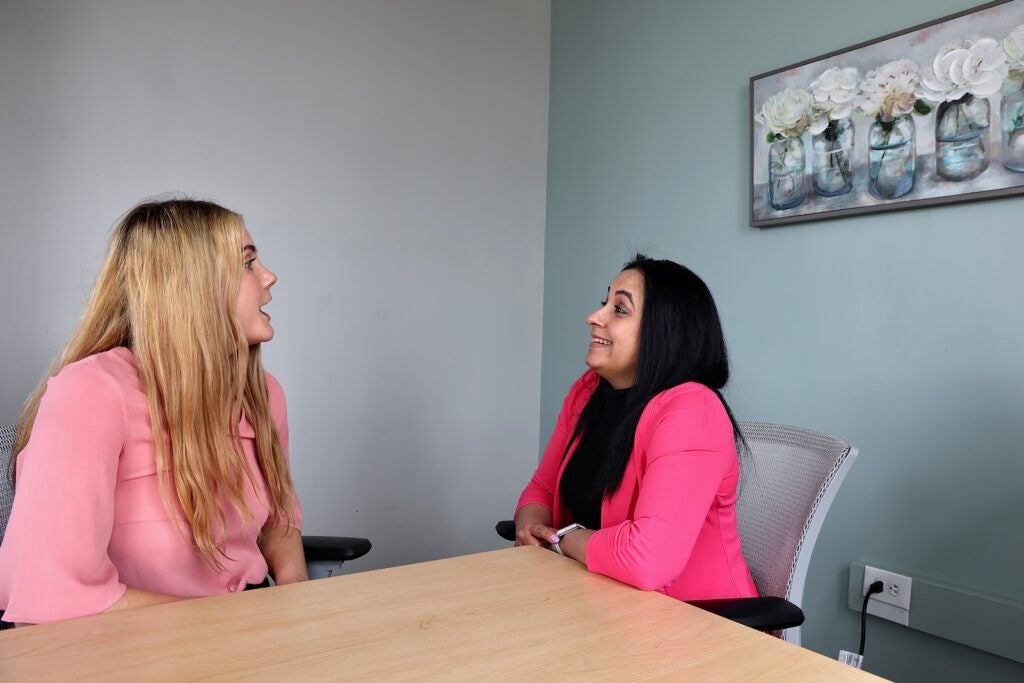Hannah Spittle (left), a bilingual learning an development specialist with Mental Health Partnership chats with Odalis Delgado, who went through the partnership's two-week intensive training a certified peer support specialist.