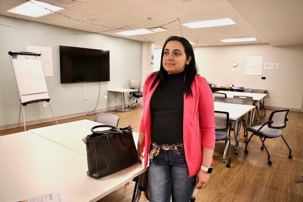 Odalis Delgado stands in the classroom at Mental Health Partnerships in Center City where she trained to be a certified peer support specialist.