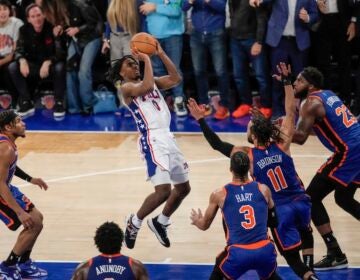 Philadelphia 76ers' Tyrese Maxey (0) shoots over New York Knicks' Jalen Brunson