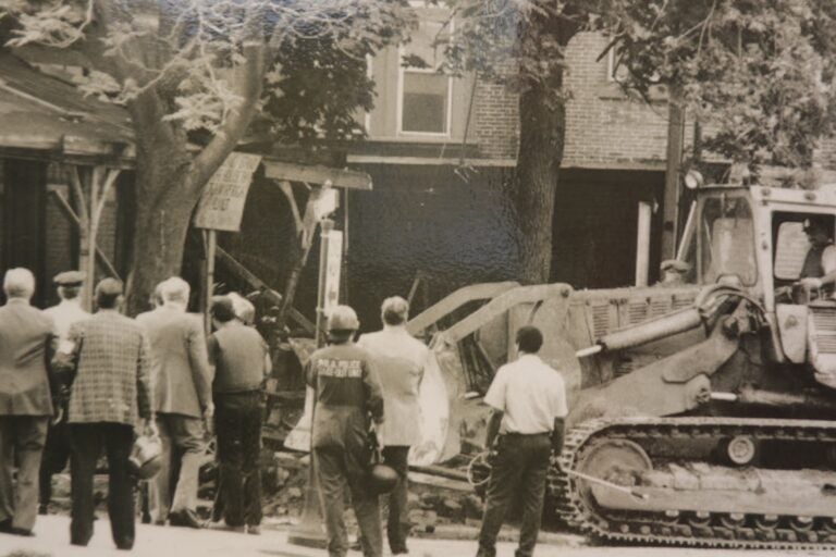 a photo of a bulldozer with people watching