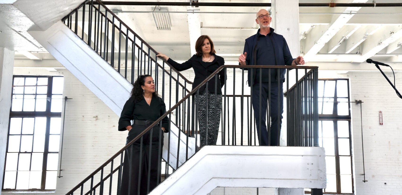 Adjoa Jones de Almeida, Michael Forman and Jennifer Rice stand on a staircase