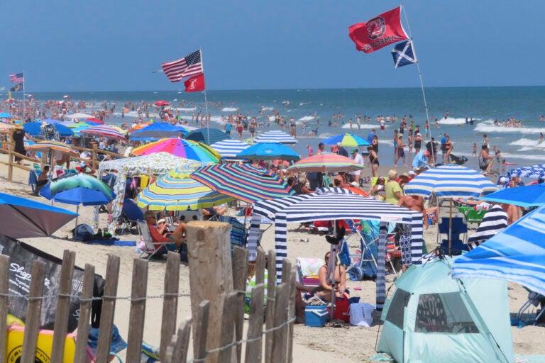Beachgoers enjoy the sand and surf in North Wildwood N.J. on July 7, 2023. (AP Photo/Wayne Parry)