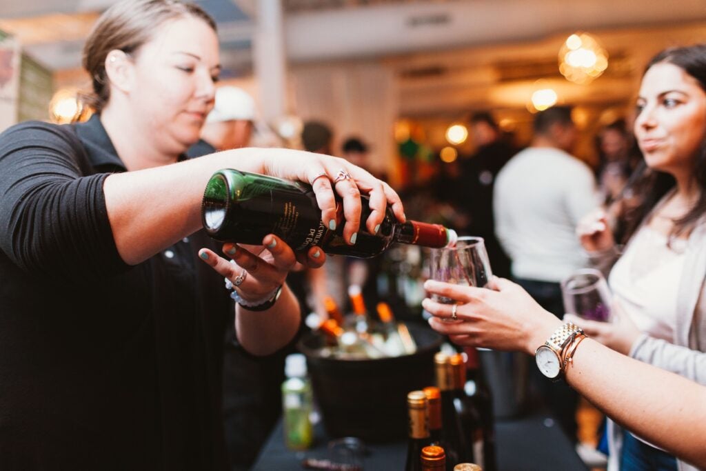 a woman pours wine