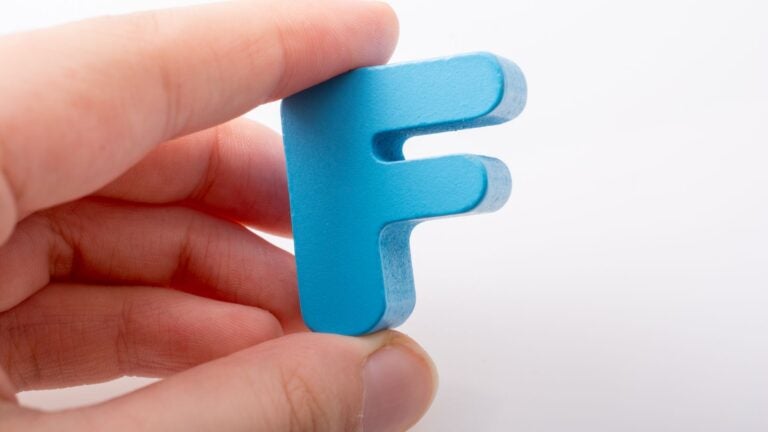 Hand hold a blue letter F