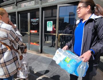 shoppers holding case of water