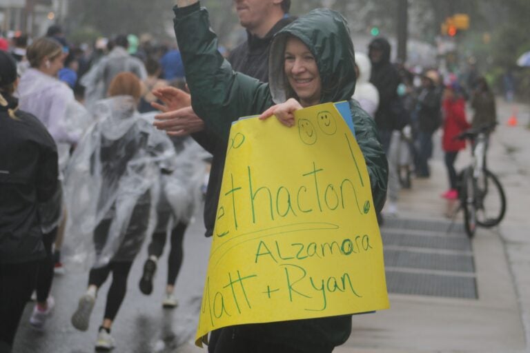 a supporter smiles at the runners