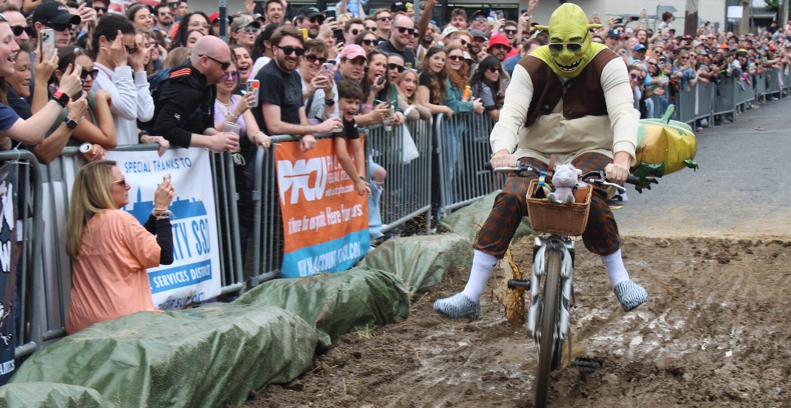 Shrek, from “The Swamp” team, rides through the mud pit at the 2024 Kensington Derby.