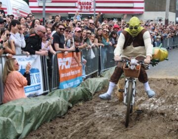 Shrek, from “The Swamp” team, rides through the mud pit at the 2024 Kensington Derby.