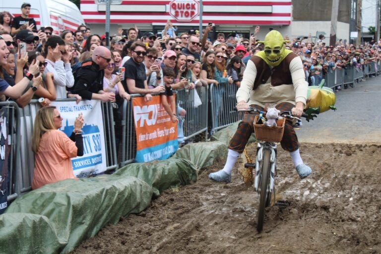 Shrek, from “The Swamp” team, rides through the mud pit at the 2024 Kensington Derby.
