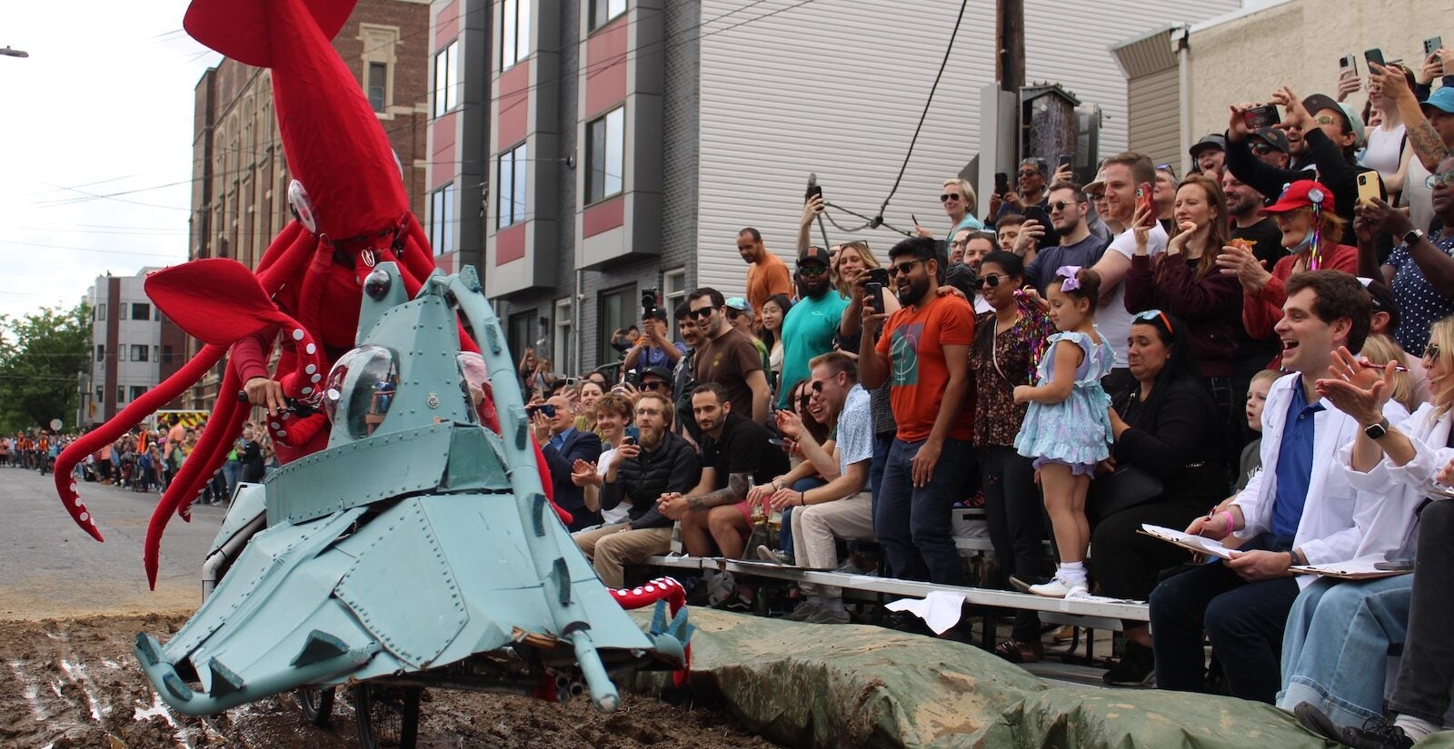 Tony Bolante appears in costume as a giant squid in the mud pit at the 2024 Kensington Derby and Arts Festival