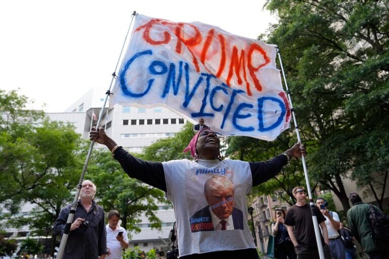A demonstrator reacts to the guilty verdict announced against former President Donald Trump outside Manhattan Criminal Court