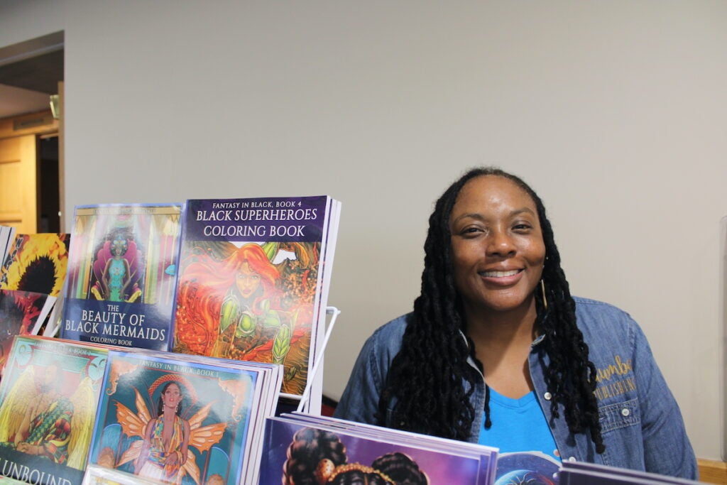 Author N.D. Jones poses with her work at the East Coast Black Age of Comics Convention