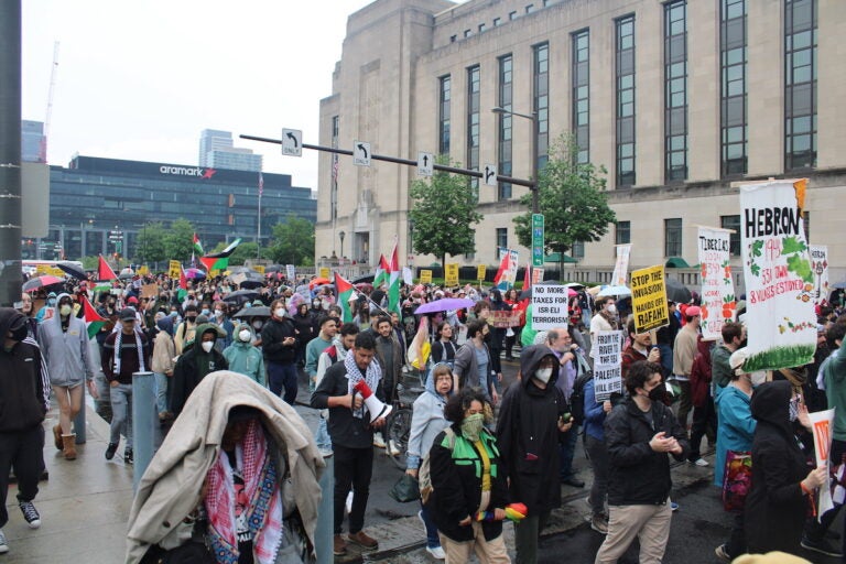 Hundreds of pro-Palestinian protesters marched from City Hall toward University City on Saturday. They linked arms and encircled a group of people setting up tents on Drexel University's campus. (Emily Neil/WHYY News)