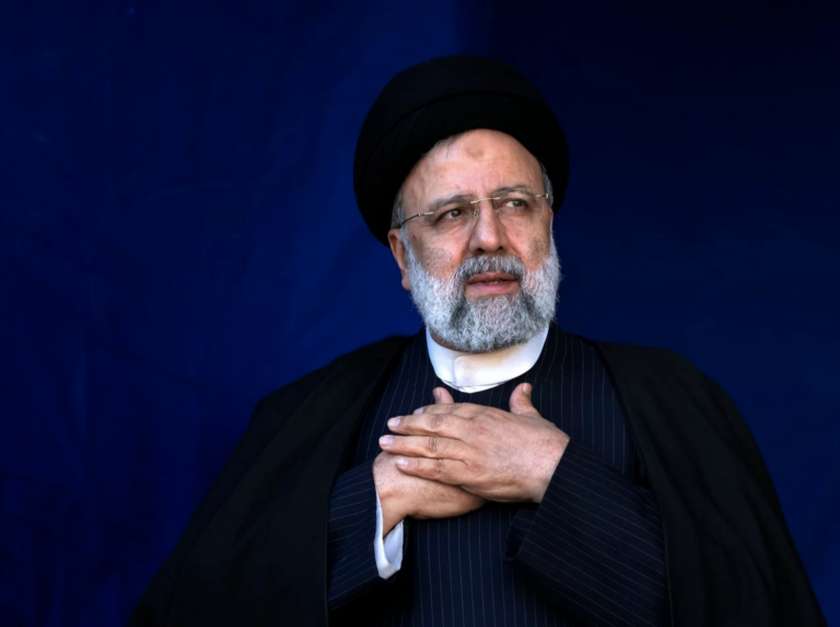 Iranian President Ebrahim Raisi is shown placing his hands on his heart as a gesture of respect to the crowd during the funeral ceremony of the victims of a bomb explosion in the city of Kerman, Iran, on Jan. 5, 2024.