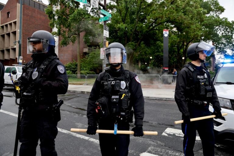 Police in riot gear block access to Penn's campus green where crews were clearing the protest encampment.