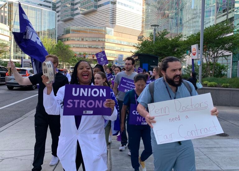 Residents cheering and holding signs at the protest