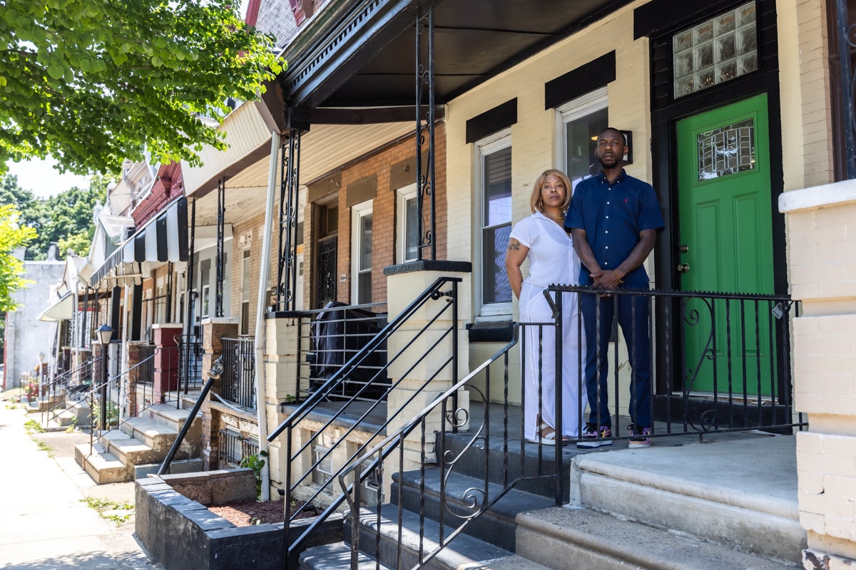 Kingzakariyah Martin with his mom, Seanee Massaquoi-Sherman, in front of the house he renovated