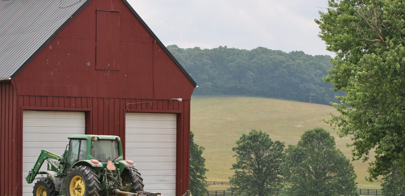 a tractor parked at a barn