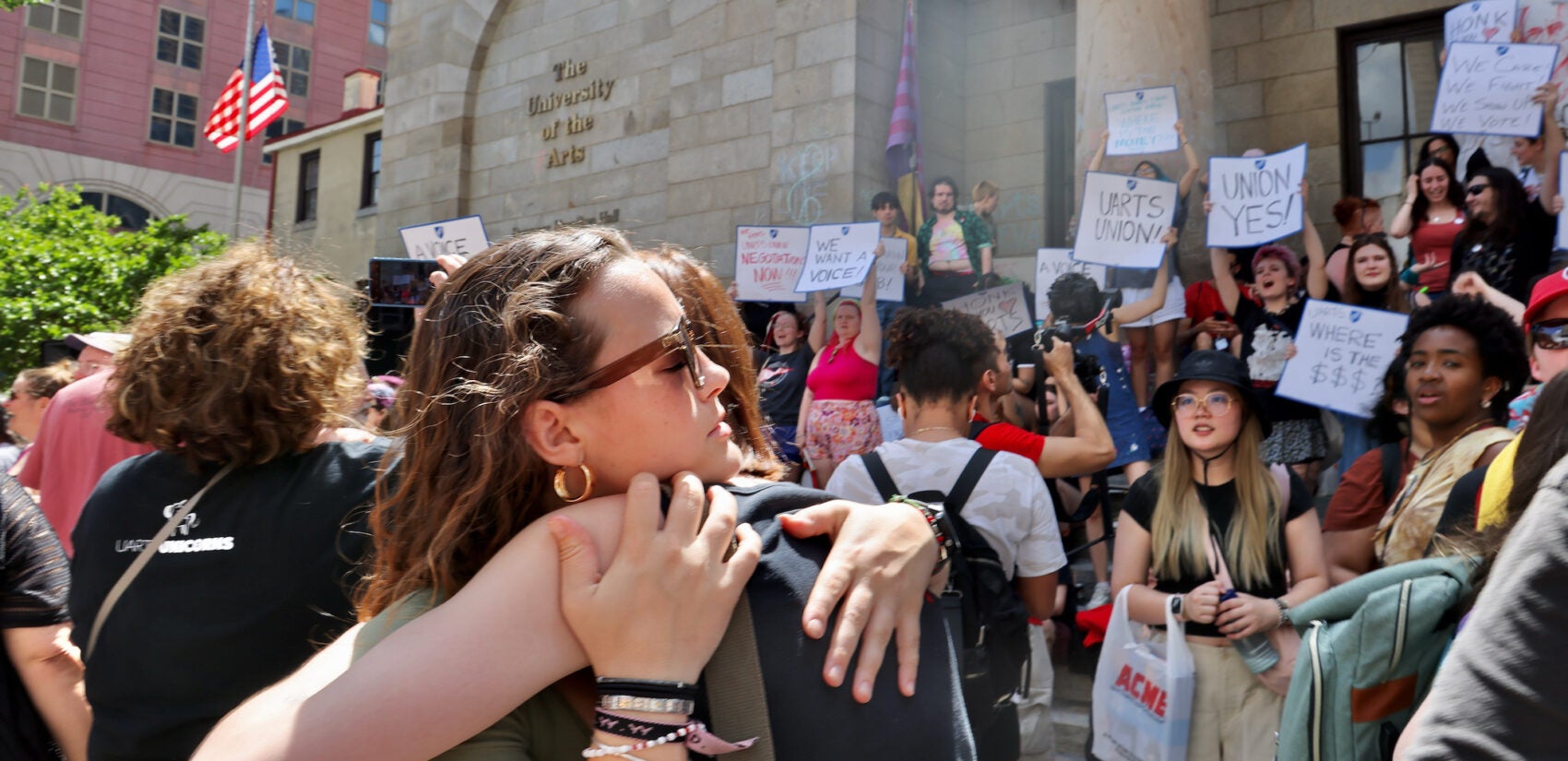 University of the Arts students Genevieve McMullen (left) and Sarah MacLeod embrace outside of Hamilton Hall, where students and faculty gathered to mark the school's last day.