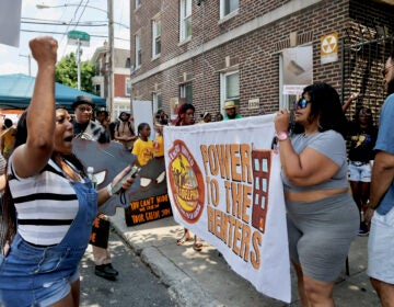 Renters march and hold a sign reading Power to the Renters