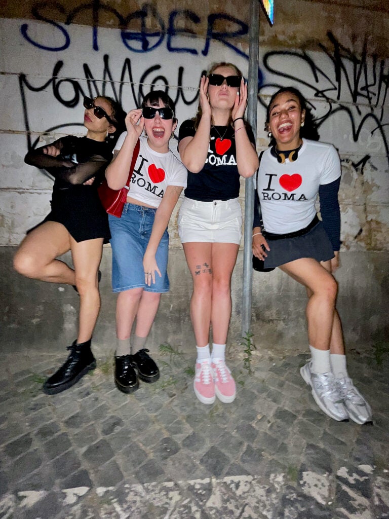 Students posing for a photo wearing 'I Love Roma' t shirts