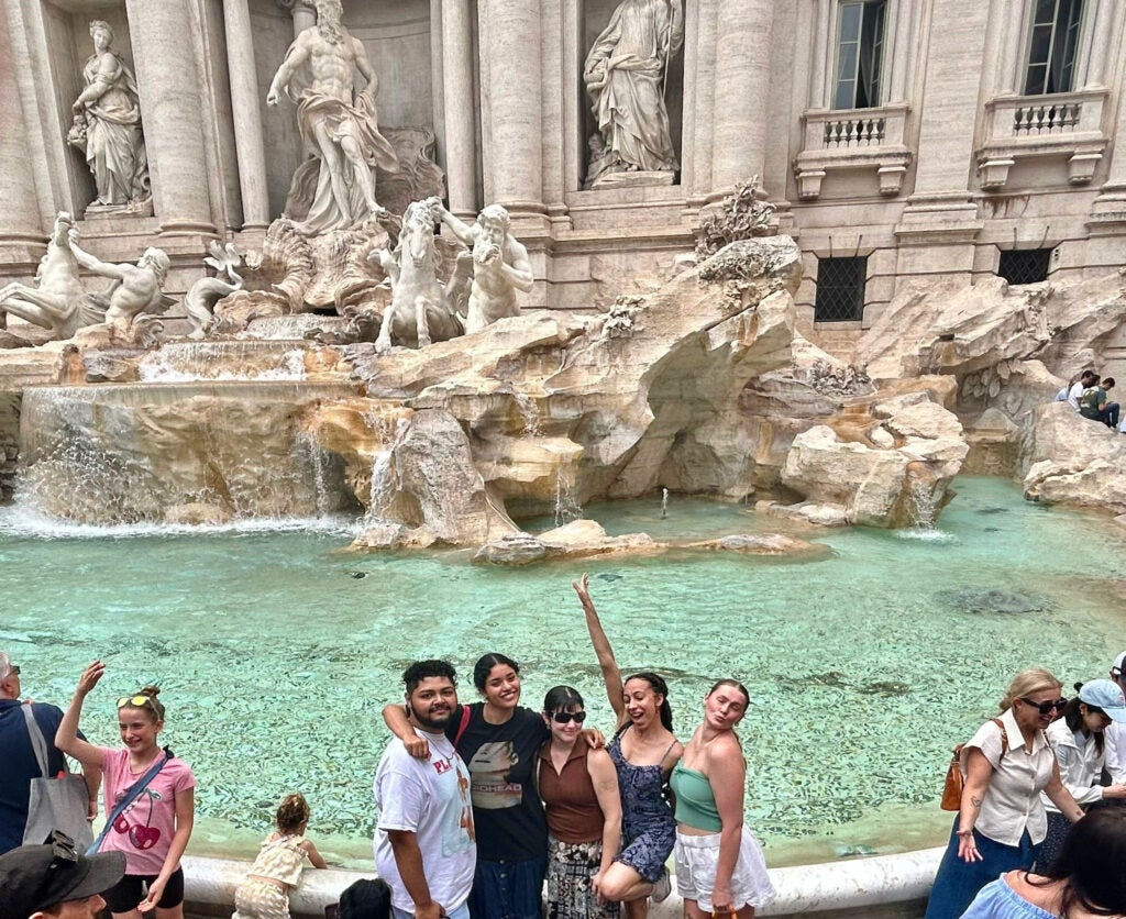 Students posing for a group photo at the fountain
