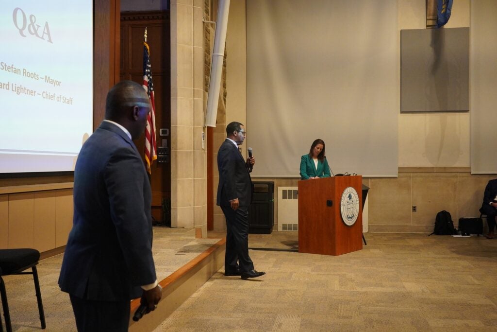 Leonard Lightner, Stefan Roots and Trish McFarland answer questions in an auditorium