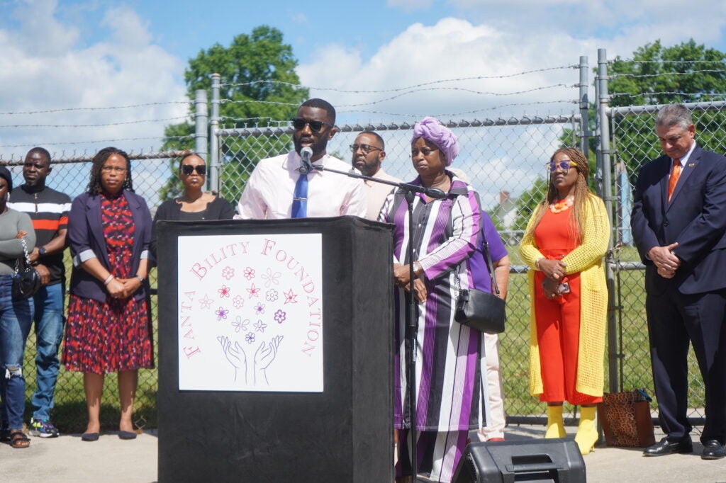 Siddiq Kamara speaking at a podium