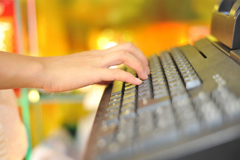 Woman's hand on cash register buttons