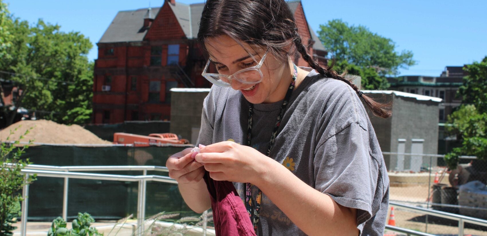 Arianna Papadakis, a rising junior at Drexel, examines the tag on an item of clothing. (Emily Neil/WHYY)