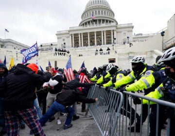 Insurrectionists try to break through a police barrier, Wednesday, Jan. 6, 2021, at the Capitol in Washington.