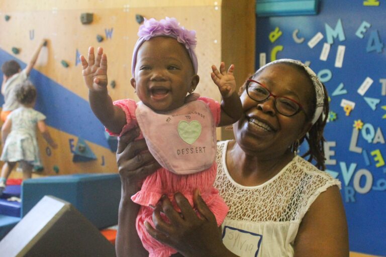 Families and children visit the Cecil B. Moore Library in Philadelphia on Sat., June 22, 2024 to celebrate the launch of the Philly Joy Bank and escape the heat wave at one of the city’s designated cooling centers. (Nicole Leonard/WHYY)