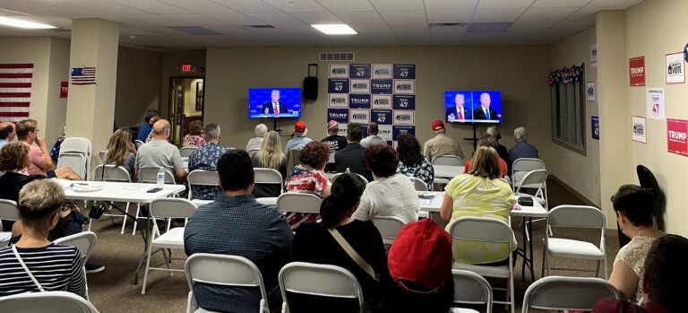 Around 50 people watch former President Donald Trump and President Joe Biden debate at the Republican watch party in Newtown, Bucks County. (Emily Neil/WHYY)