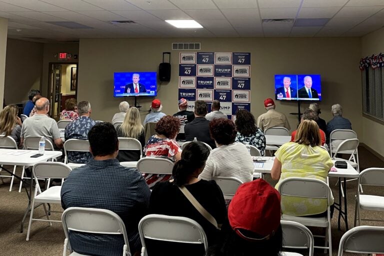 Around 50 people watch former President Donald Trump and President Joe Biden debate at the Republican watch party in Newtown, Bucks County. (Emily Neil/WHYY)