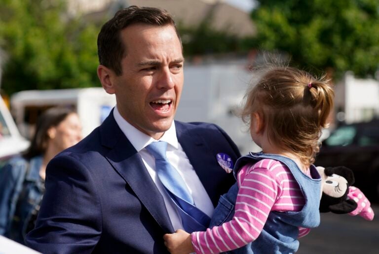 Rob Menendez, son of U.S. Sen. Bob Menendez, greets supporters while holding his daughter Olivia, 2, after voting in Jersey City, N.J., June 7, 2022. In northern New Jersey's 8th District, incumbent Democratic Rep. Rob Menendez — the senator's son — is seeking reelection against Hoboken Mayor Ravi Bhalla, who's tried to tie Rob Menendez to his father. (AP Photo/Seth Wenig, File)