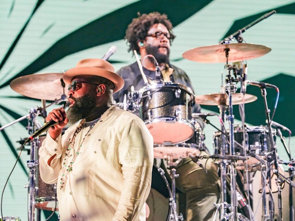 Black Thought and Questlove on stage performing as The Roots