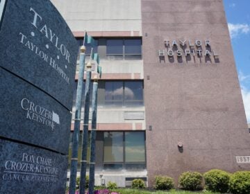 a sign for Taylor Hospital in front of the hospital