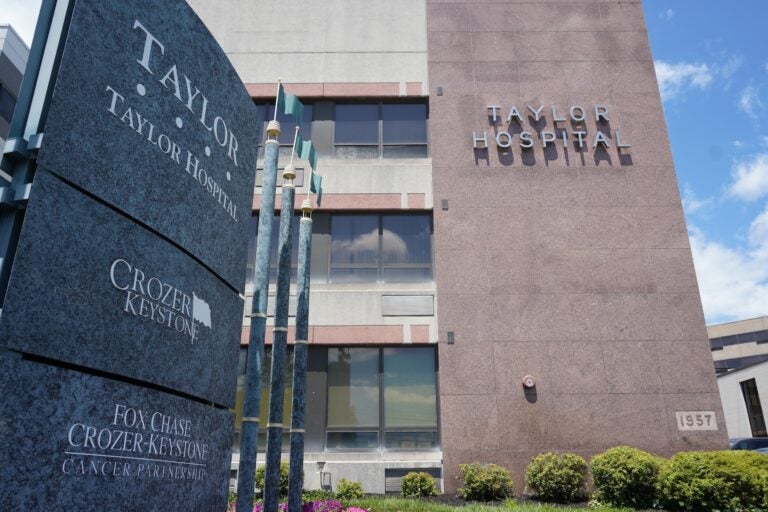 a sign for Taylor Hospital in front of the hospital