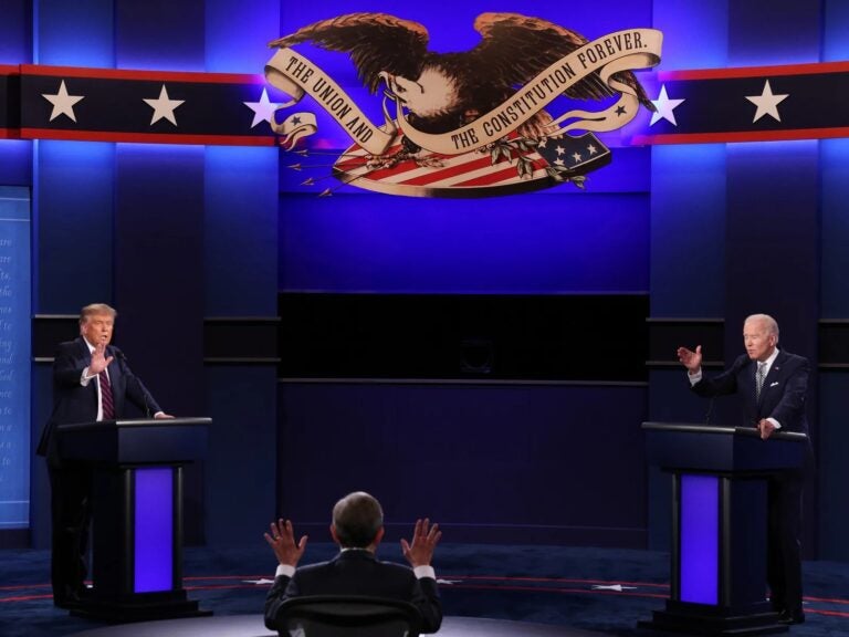 Then-President Donald Trump and then-Democratic presidential nominee Joe Biden participate in a presidential debate moderated by then-Fox News anchor Chris Wallace on Sept. 29, 2020, in Cleveland. This year, the first presidential debate will not have an audience but will have a mute button. (Scott Olson/Getty Images)