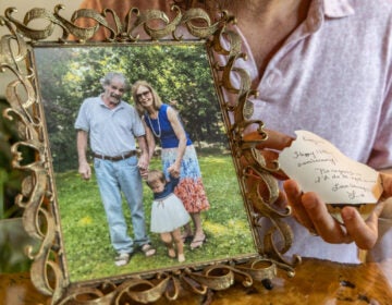 Zack DePiero displays a photo of his parents