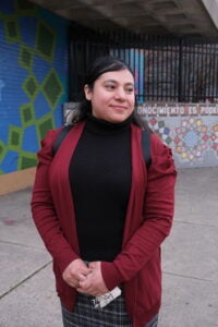 Claudia stands outside the Free Migration Project offices in Philadelphia. (Alan Jinich/For WHYY)