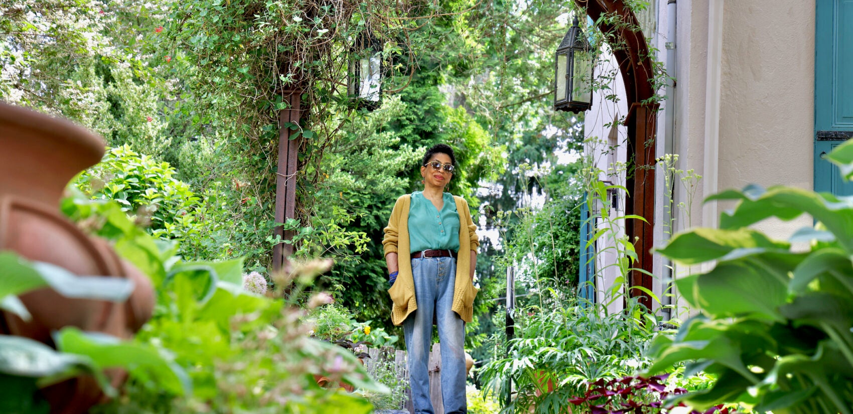 Syd Carpenter stands in her garden in Mount Airy.