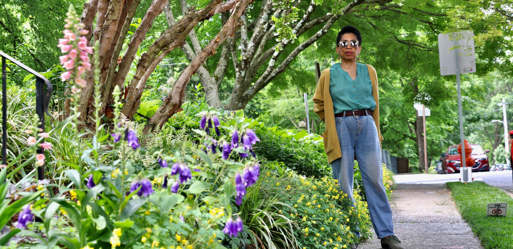 Syd Carpenter stands beside her garden