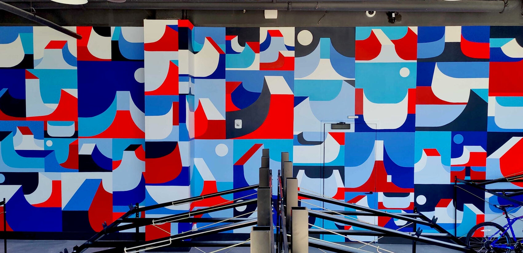 The bicycle parking room of The Noble apartment building features an abstract grid of skateboard ramps painted by Philadelphia artist Jim Houser. (Peter Crimmins/WHYY)